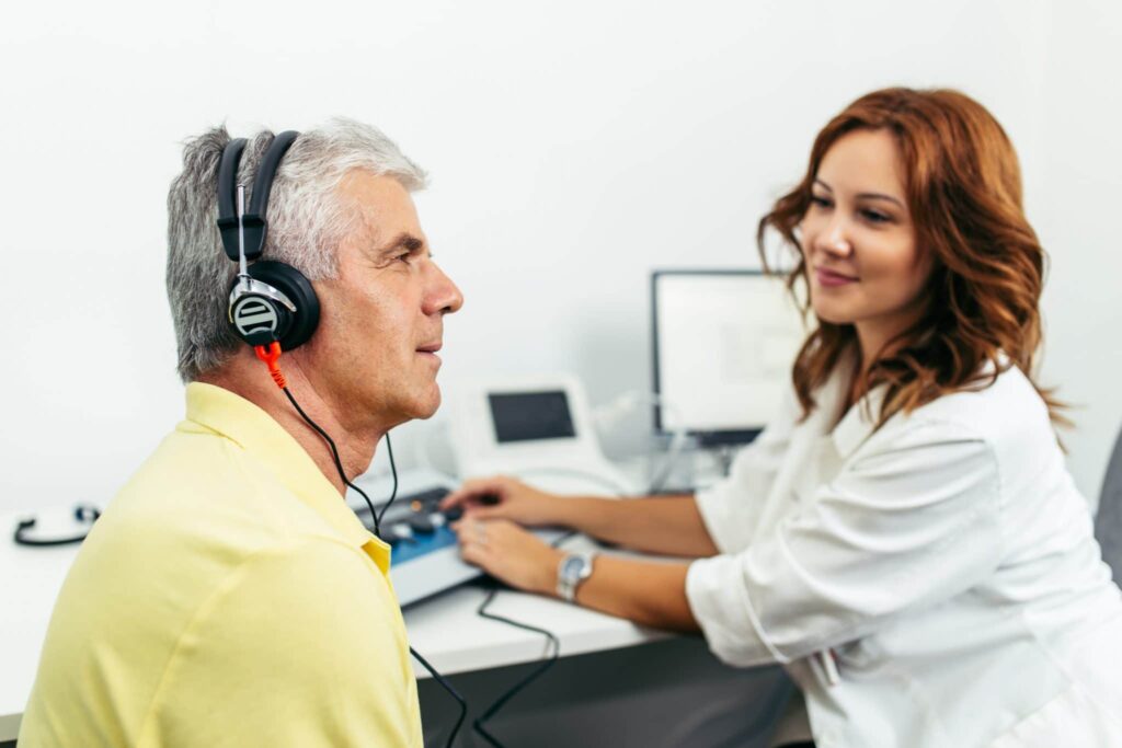 man hearing test hearing aids scaled 1